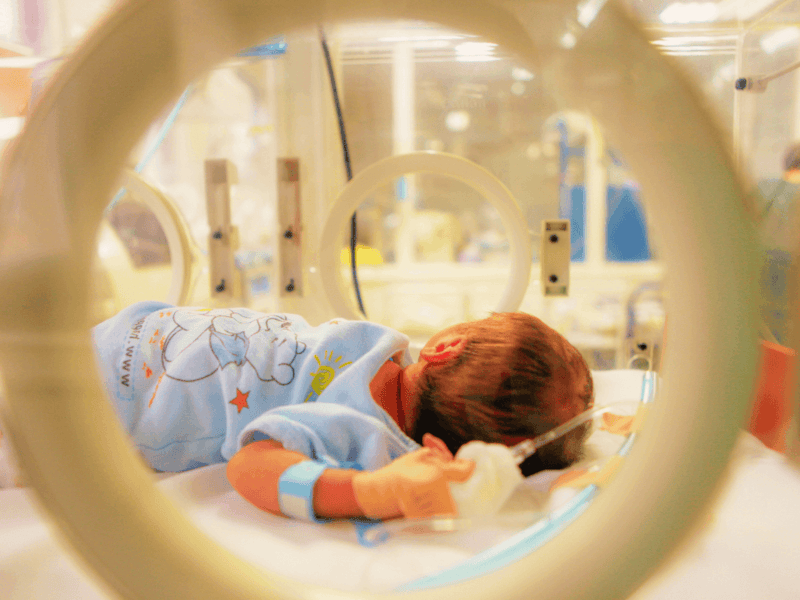 Baby in incubator in neonatology unit